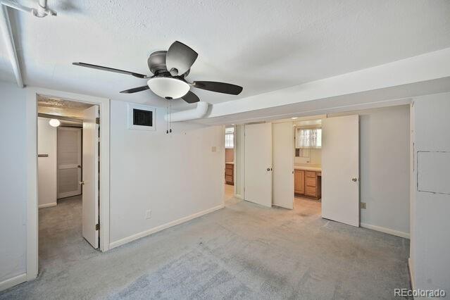 321 S Gilpin St, Denver, CO 80209 - unfurnished bedroom with light colored carpet and a textured ceiling