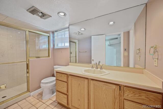 321 S Gilpin St, Denver, CO 80209 - bathroom with a shower stall, vanity, recessed lighting, and tile patterned floors
