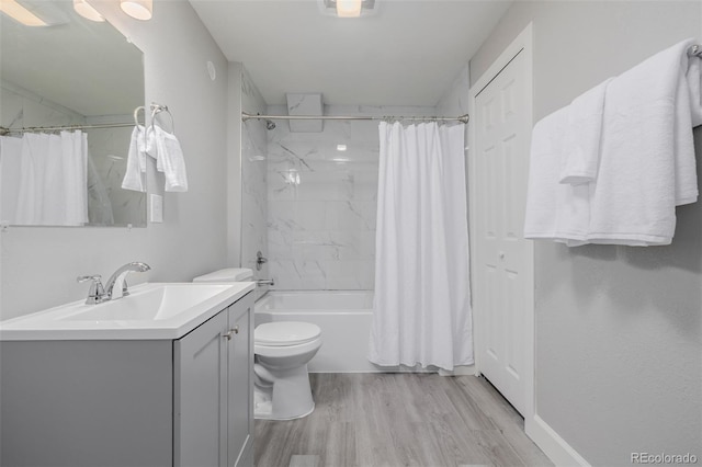 full bathroom featuring toilet, vanity, shower / bath combination with curtain, and hardwood / wood-style floors