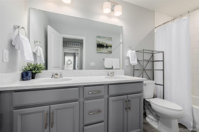 full bathroom featuring toilet, vanity, and shower / bathtub combination with curtain