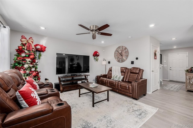 living room featuring light wood-type flooring and ceiling fan