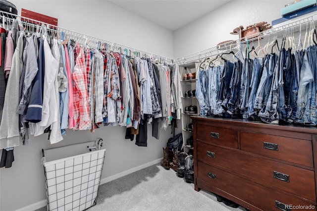 walk in closet featuring light colored carpet