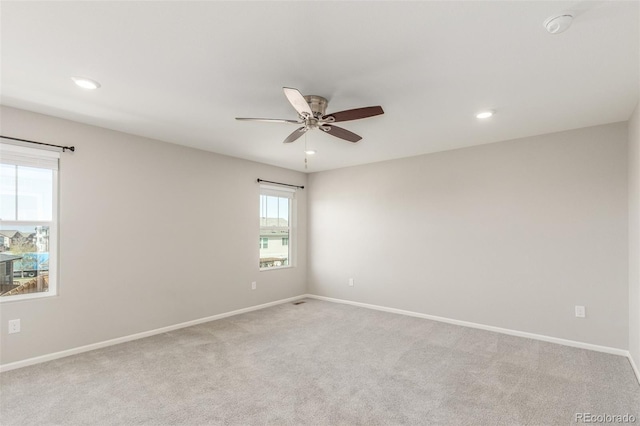 unfurnished room with light carpet, baseboards, and ceiling fan