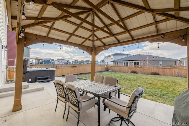 view of patio featuring a gazebo, outdoor dining area, a fenced backyard, and a hot tub