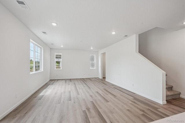 4246 Graywood Dr, Johnstown, CO 80534 - unfurnished living room with light wood-style flooring, recessed lighting, stairway, and baseboards