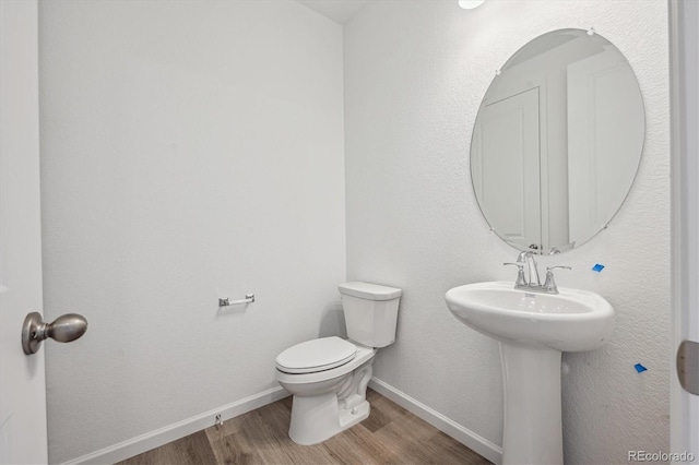 4246 Graywood Dr, Johnstown, CO 80534 - half bath featuring wood finished floors, toilet, and baseboards