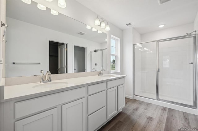 4246 Graywood Dr, Johnstown, CO 80534 - full bathroom with a shower stall, wood finished floors, double vanity, and recessed lighting