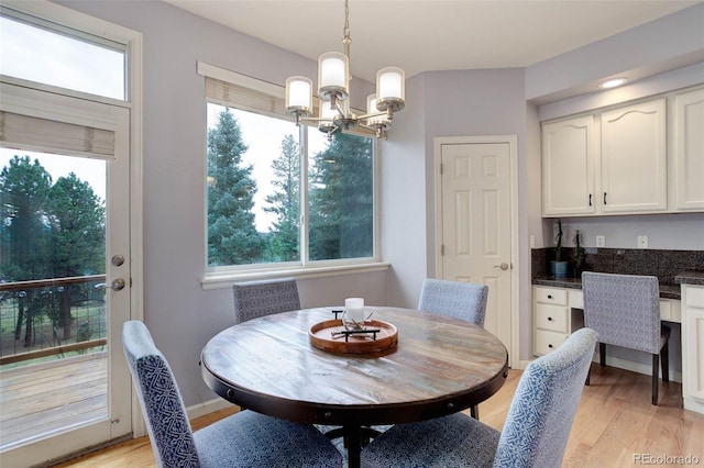 dining space with an inviting chandelier and light hardwood / wood-style floors