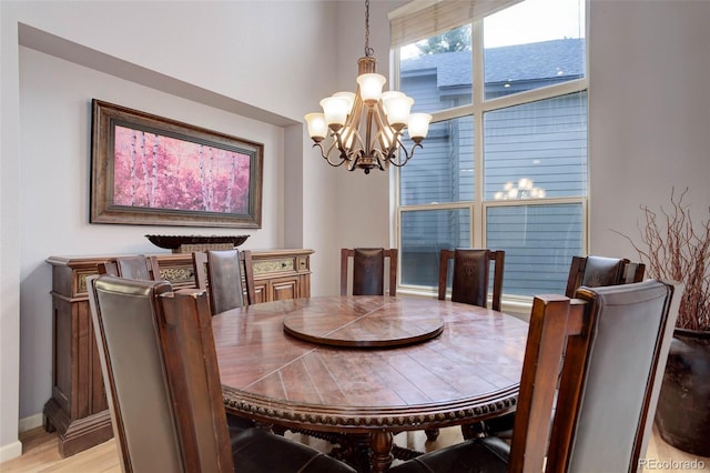 dining area with an inviting chandelier and light wood-type flooring