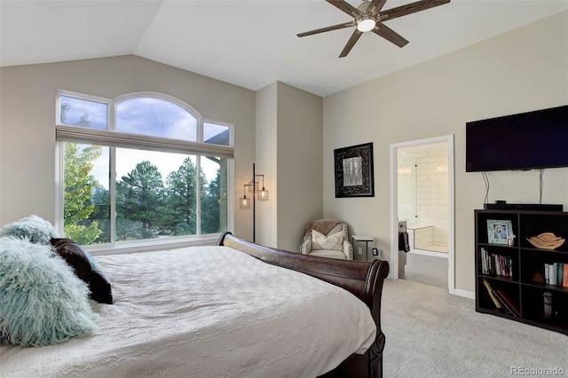 bedroom featuring light carpet, lofted ceiling, ensuite bath, and ceiling fan