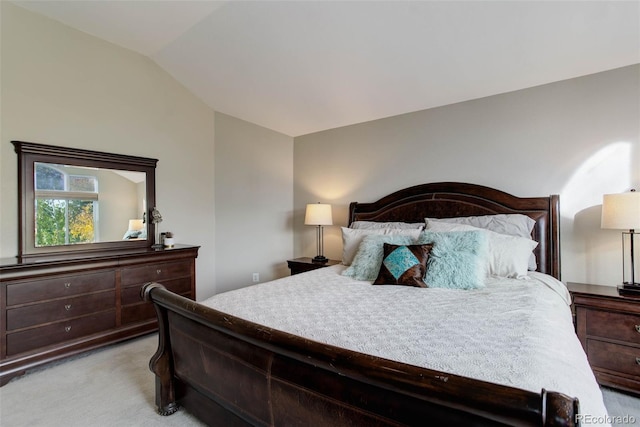 bedroom featuring vaulted ceiling and light carpet