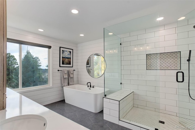 bathroom with tile patterned flooring, separate shower and tub, and vanity