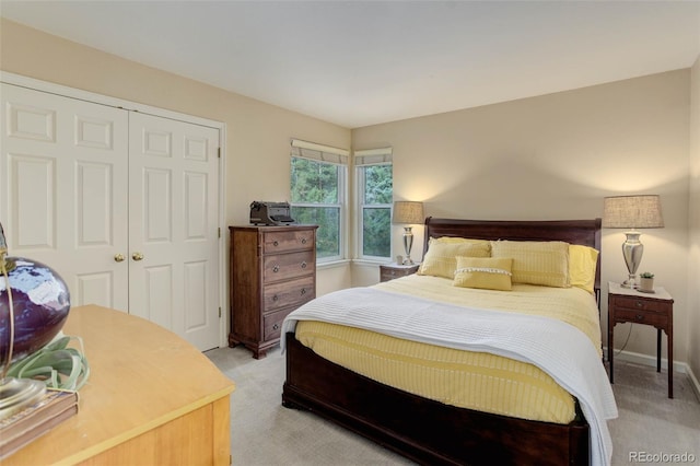 bedroom featuring light carpet and a closet