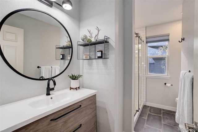 bathroom with vanity, a shower with shower door, and toilet