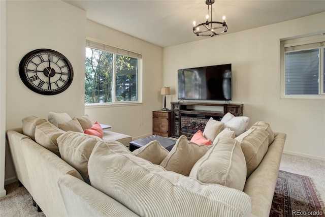 living room featuring an inviting chandelier and light colored carpet