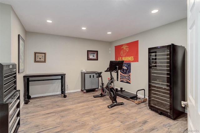 workout room featuring wine cooler and hardwood / wood-style flooring