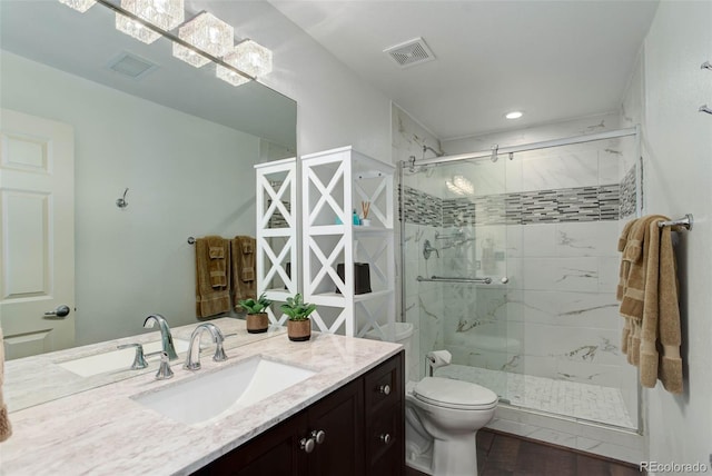 bathroom featuring vanity, toilet, and an enclosed shower