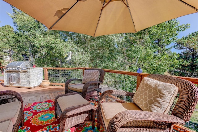 wooden deck with an outdoor living space, an outdoor kitchen, and grilling area