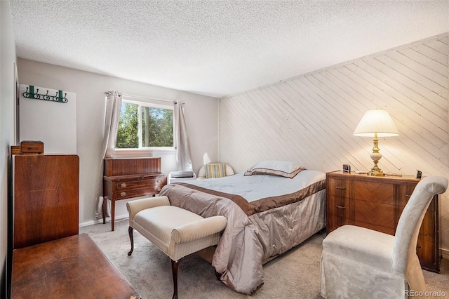 carpeted bedroom featuring a textured ceiling and vaulted ceiling