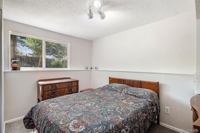 carpeted bedroom with a textured ceiling