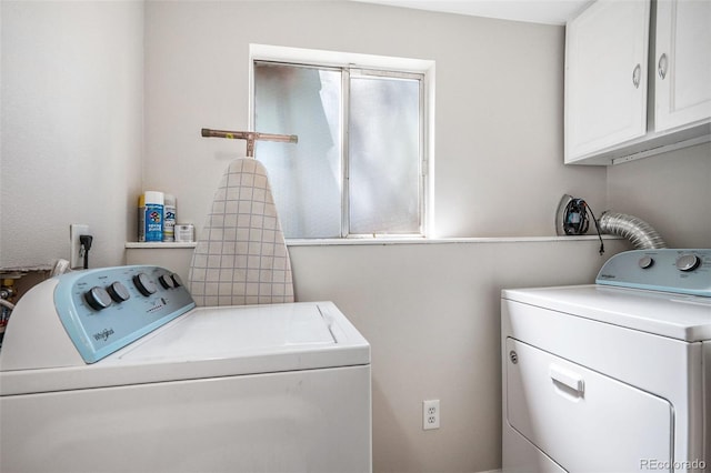 washroom featuring cabinets and independent washer and dryer