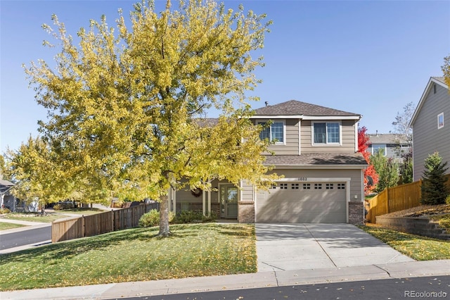 view of front of property featuring a garage and a front lawn