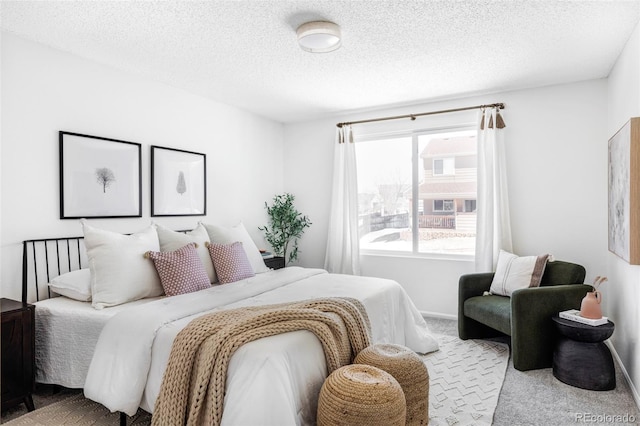 carpeted bedroom with a textured ceiling