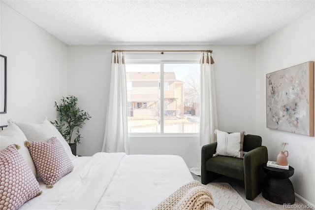 carpeted bedroom featuring a textured ceiling