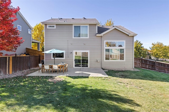 back of house featuring a yard and a patio