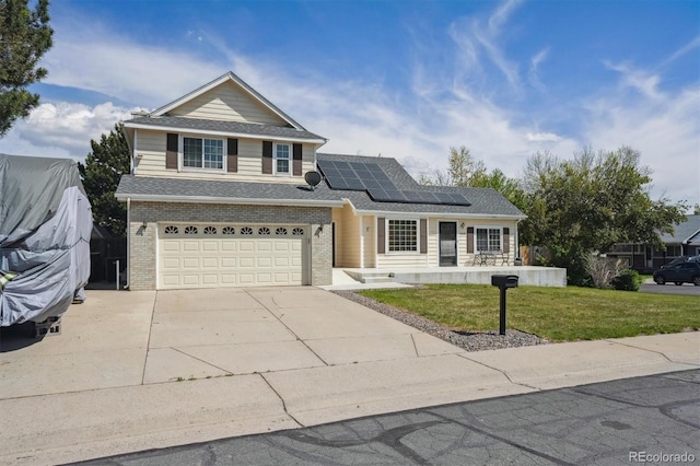 9908 Garfield Ct, Thornton, CO 80229 - traditional home with driveway, a front lawn, roof mounted solar panels, a garage, and brick siding