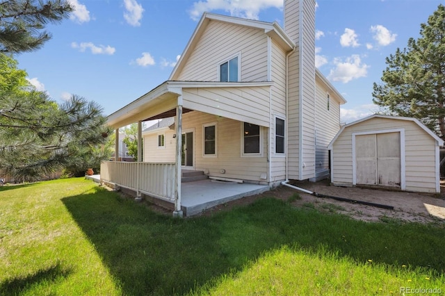 9908 Garfield Ct, Thornton, CO 80229 - back of house featuring a shed, a chimney, a lawn, an outdoor structure, and a patio area