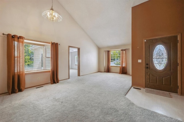 9908 Garfield Ct, Thornton, CO 80229 - foyer entrance featuring high vaulted ceiling, a chandelier, carpet flooring, and baseboards
