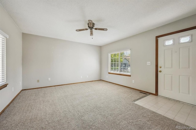 9908 Garfield Ct, Thornton, CO 80229 - carpeted foyer with a ceiling fan, a textured ceiling, and baseboards