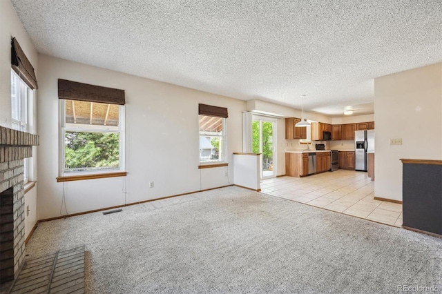 9908 Garfield Ct, Thornton, CO 80229 - unfurnished living room with light carpet, baseboards, a textured ceiling, light tile patterned floors, and a brick fireplace