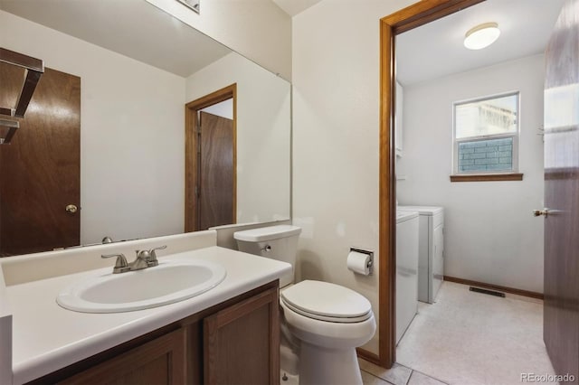 9908 Garfield Ct, Thornton, CO 80229 - bathroom with separate washer and dryer, toilet, vanity, and baseboards