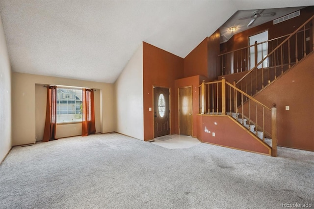 9908 Garfield Ct, Thornton, CO 80229 - unfurnished living room with high vaulted ceiling, carpet floors, stairs, and ceiling fan