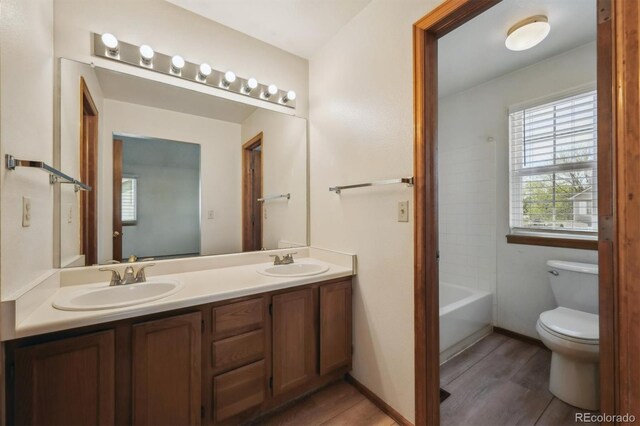 9908 Garfield Ct, Thornton, CO 80229 - bathroom featuring toilet, wood finished floors, and double vanity
