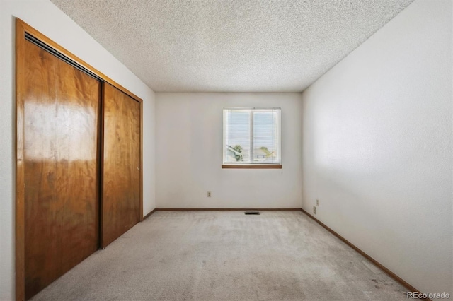 9908 Garfield Ct, Thornton, CO 80229 - unfurnished bedroom with light carpet, a closet, a textured ceiling, and baseboards