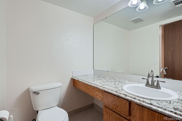 half bath featuring toilet, tile patterned flooring, visible vents, and vanity