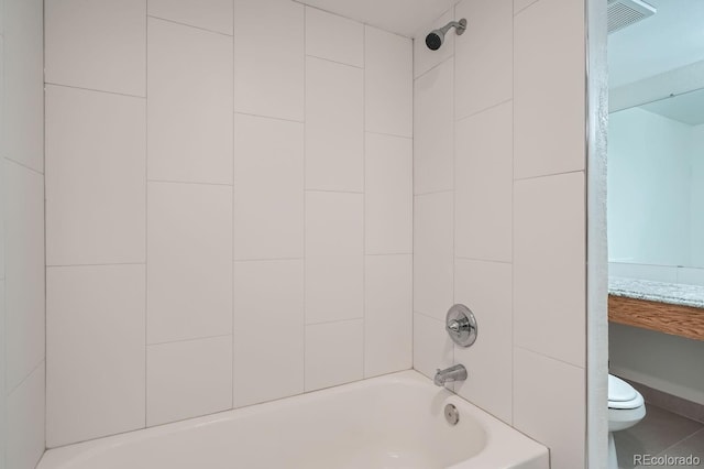 bathroom featuring shower / bath combination and toilet