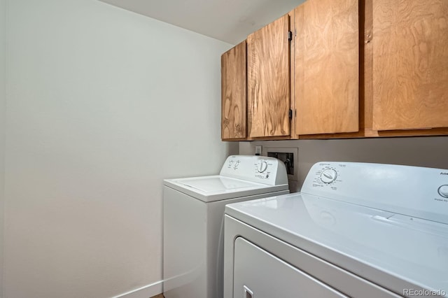 laundry area featuring cabinet space, washing machine and dryer, and baseboards