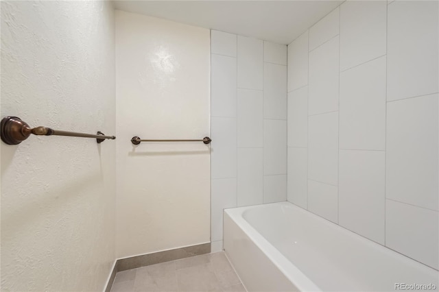 bathroom with baseboards, a tub, tile patterned floors, and a shower