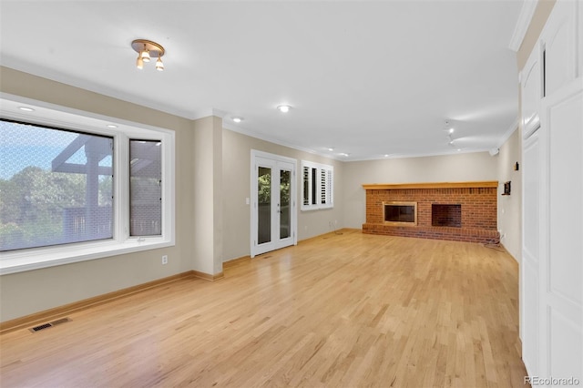 5622 E Weaver Cir, Centennial, CO 80111 - unfurnished living room with ornamental molding, light wood finished floors, a brick fireplace, baseboards, and recessed lighting