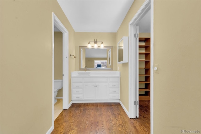 5622 E Weaver Cir, Centennial, CO 80111 - bathroom featuring wood finished floors, vanity, toilet, and baseboards