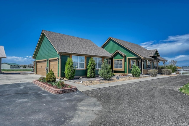 55610 E 40th Ave, Strasburg, CO 80136 - ranch-style home featuring asphalt driveway, roof with shingles, and a garage