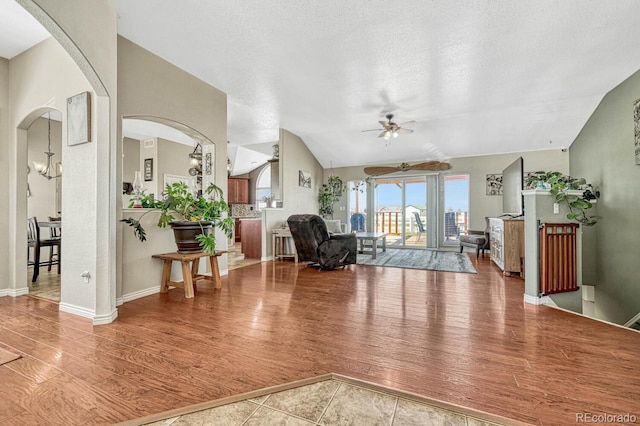 55610 E 40th Ave, Strasburg, CO 80136 - living area with ceiling fan, wood finished floors, arched walkways, and vaulted ceiling
