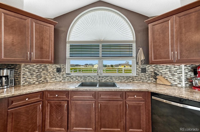 55610 E 40th Ave, Strasburg, CO 80136 - kitchen with dishwashing machine, backsplash, lofted ceiling, and light stone countertops