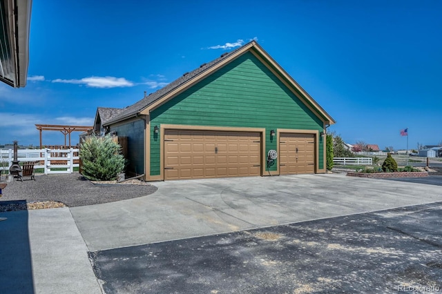 55610 E 40th Ave, Strasburg, CO 80136 - view of side of property with concrete driveway and an attached garage