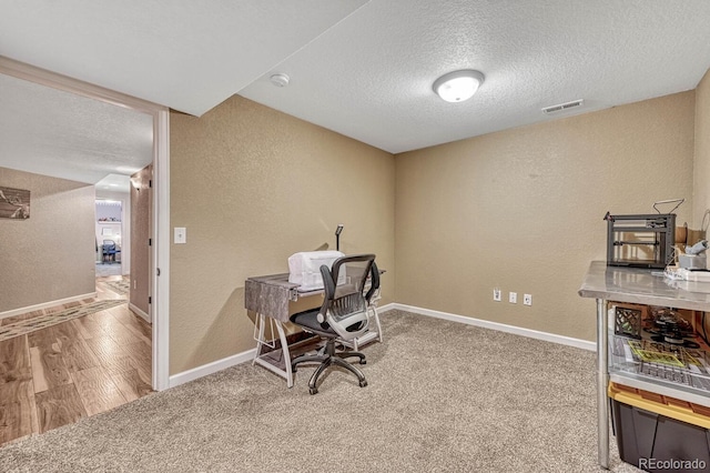 55610 E 40th Ave, Strasburg, CO 80136 - carpeted office with a textured ceiling, a textured wall, and wood finished floors