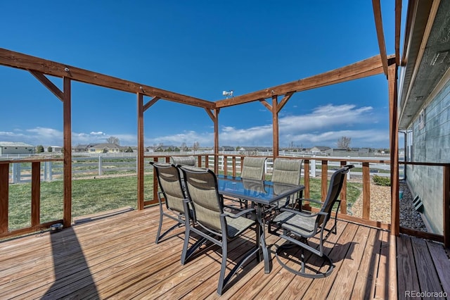 55610 E 40th Ave, Strasburg, CO 80136 - wooden deck featuring outdoor dining area and a lawn
